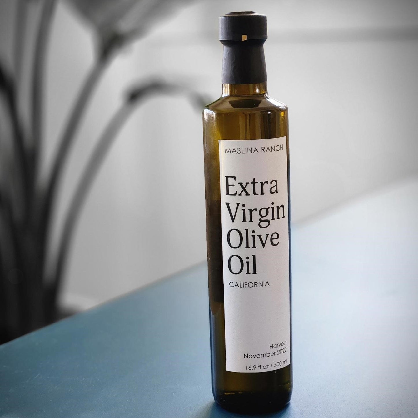 a bottle of Maslina Ranch olive oil on a table